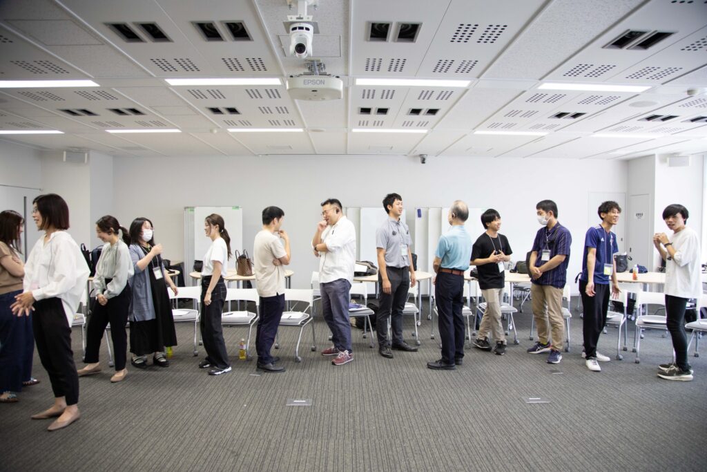 Participants talking in a bright classroom during a session