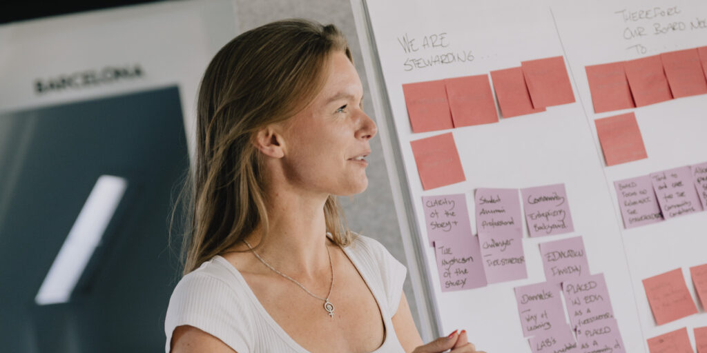A student in front of a wall of sticky notes during a workshop